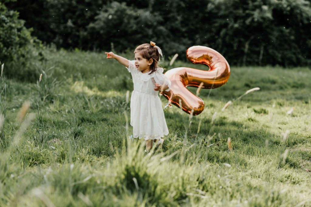 a girl holding a balloon photography burton outdoor children family portrait photographer derbyshire burton on trent